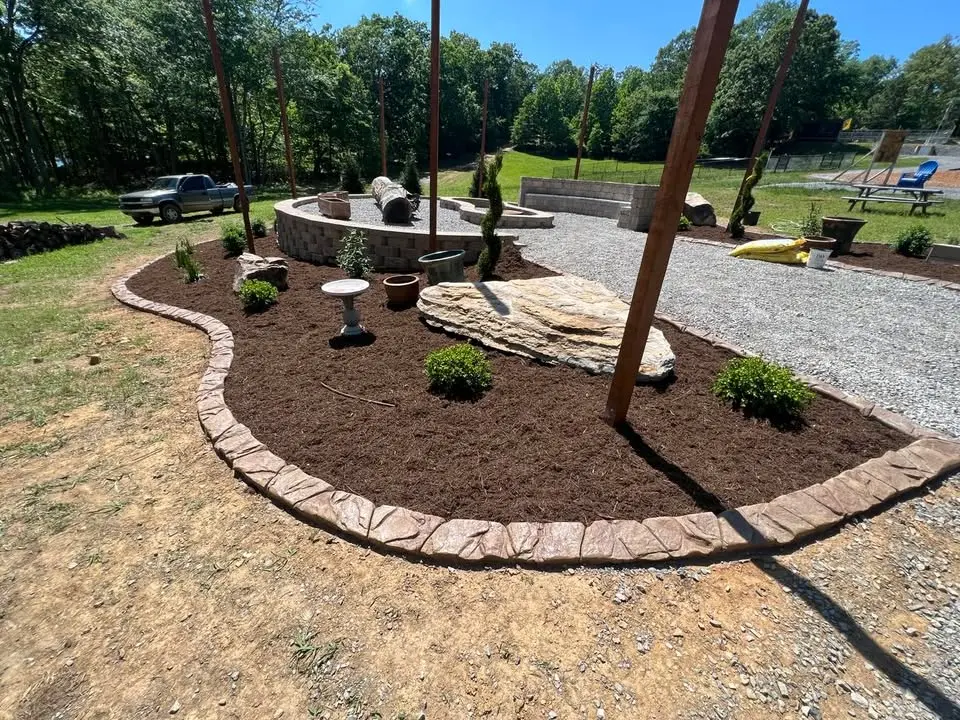 Continuous concrete landscape curbing along driveway by The Muscle