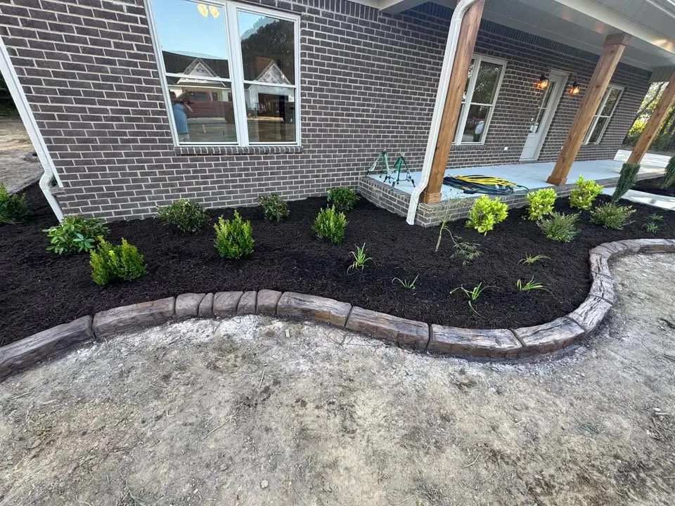 Decorative concrete border around mulch bed by The Muscle