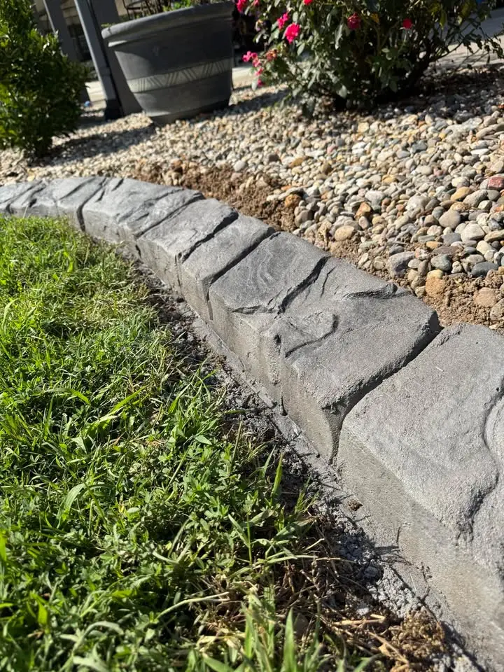 Concrete curbing with stamped pattern installed by The Muscle