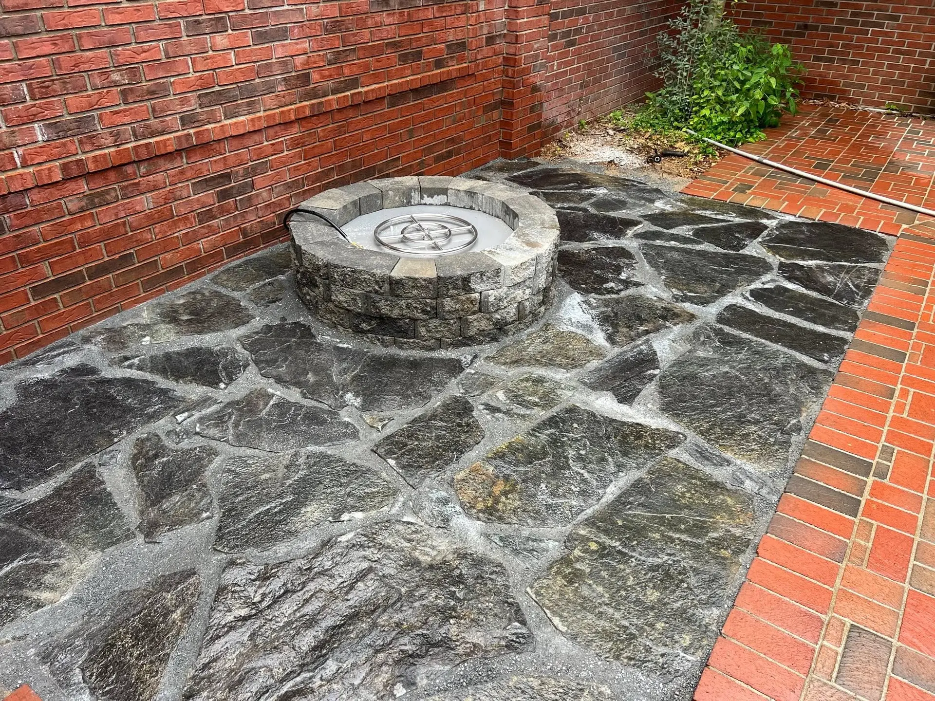 Custom paver patio and outdoor living hardscape installation by The Muscle