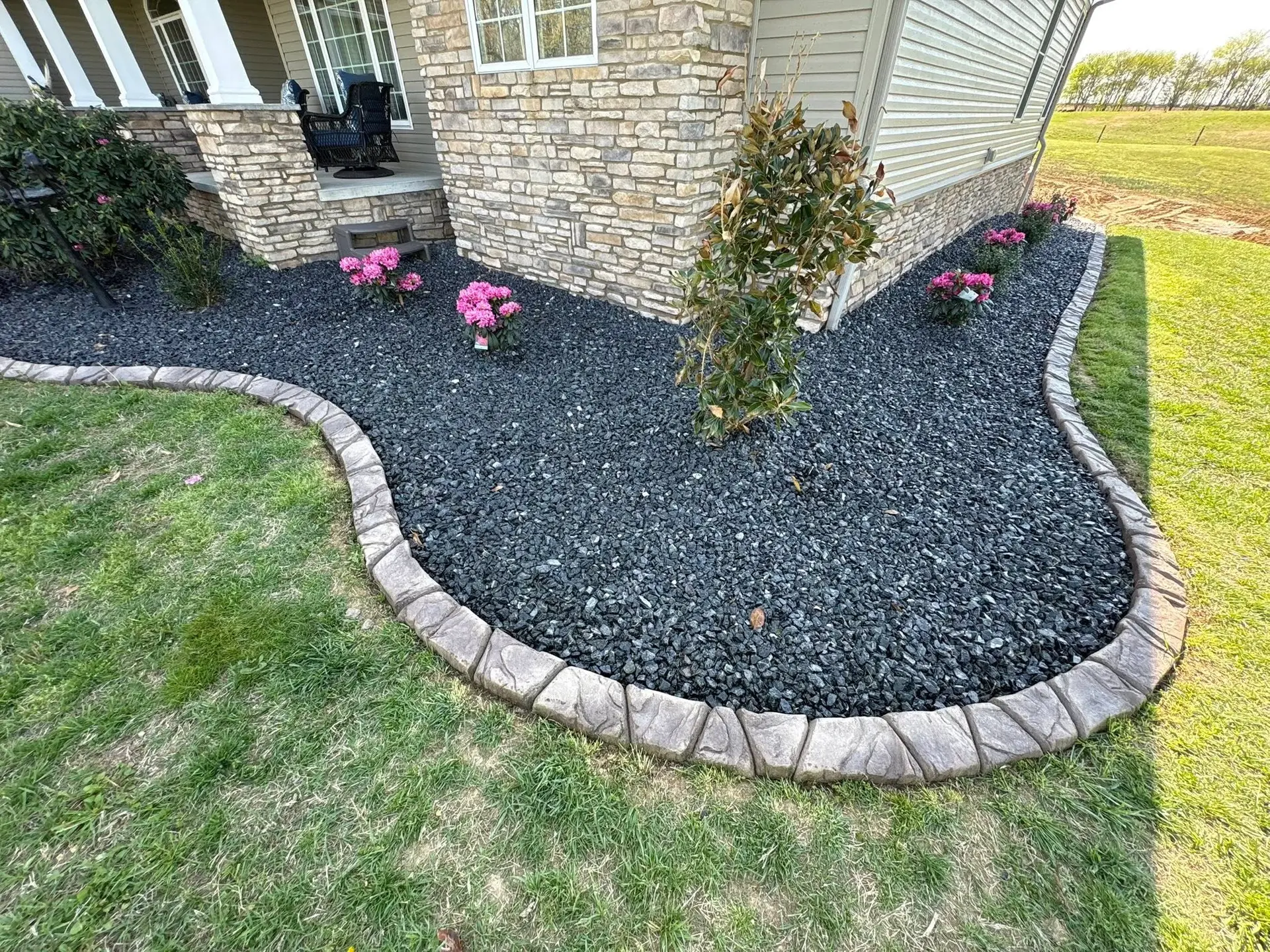 Full-service landscaping with stone, paver and gravel work installed by The Muscle