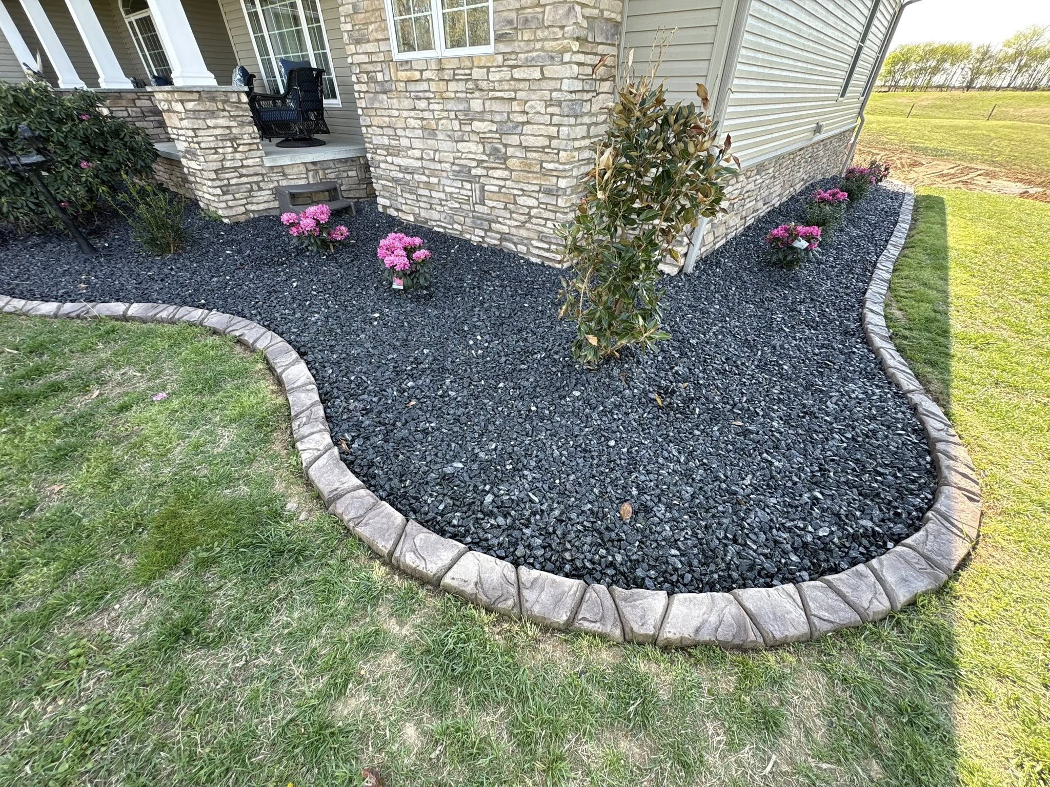Full-service landscaping with stone, paver and gravel work installed by The Muscle
